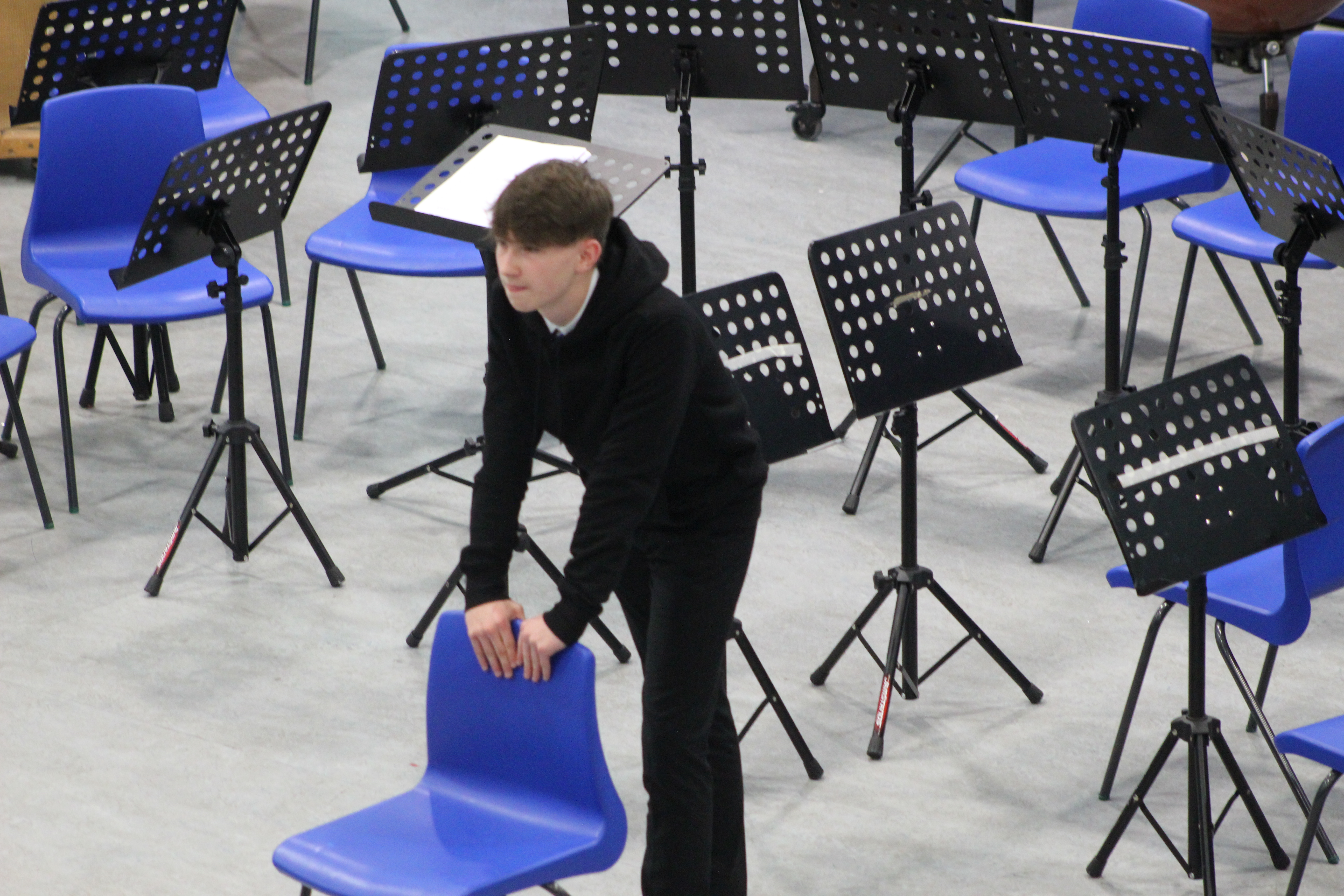 student leaning on chair